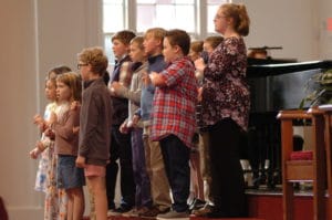 Children leading a song together on Sunday morning.